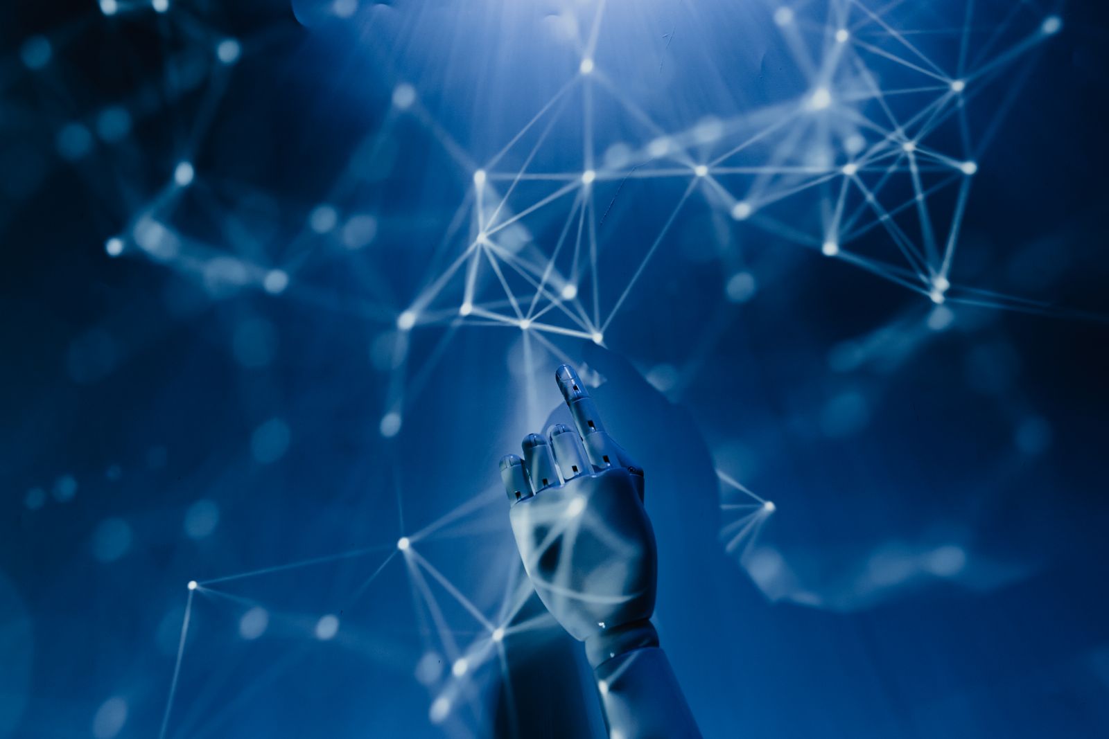 AI-generated robotic hand reaching into a glowing network of connections — representing deepfake identity fraud